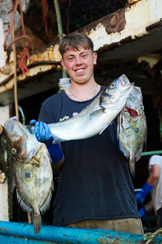 Fisherman-Holding-Fish-At-Brixham-Fish-Market